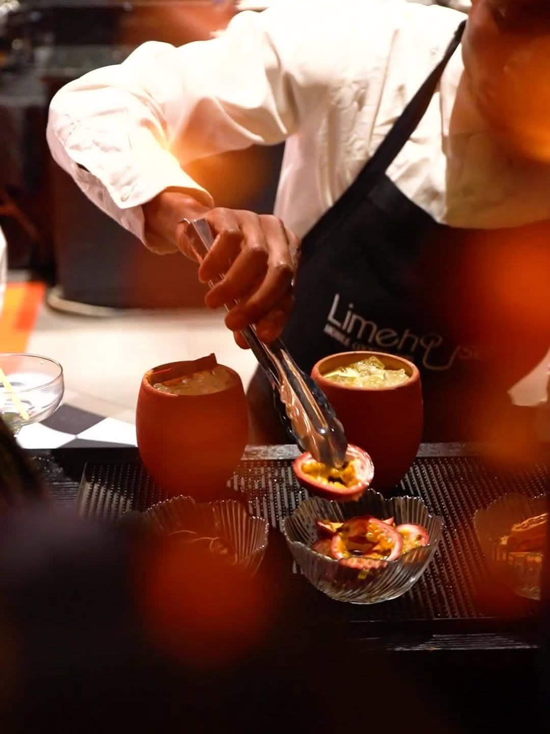 A Limehouse bartender crafting cocktails in clay cups