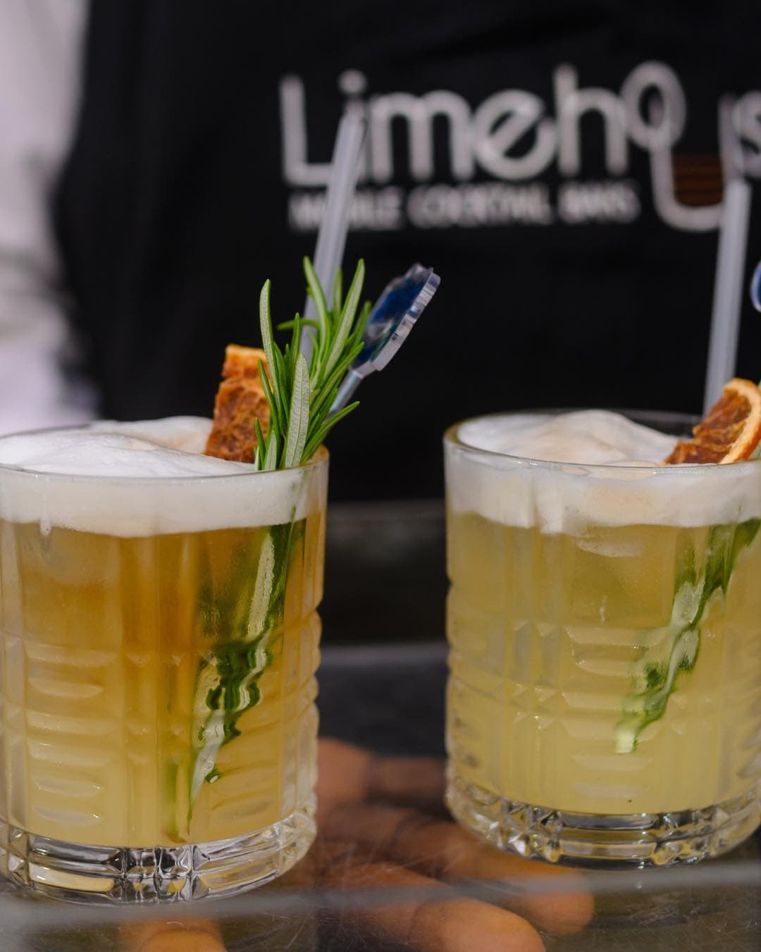 Yellow whiskey sour cocktails with rosemary